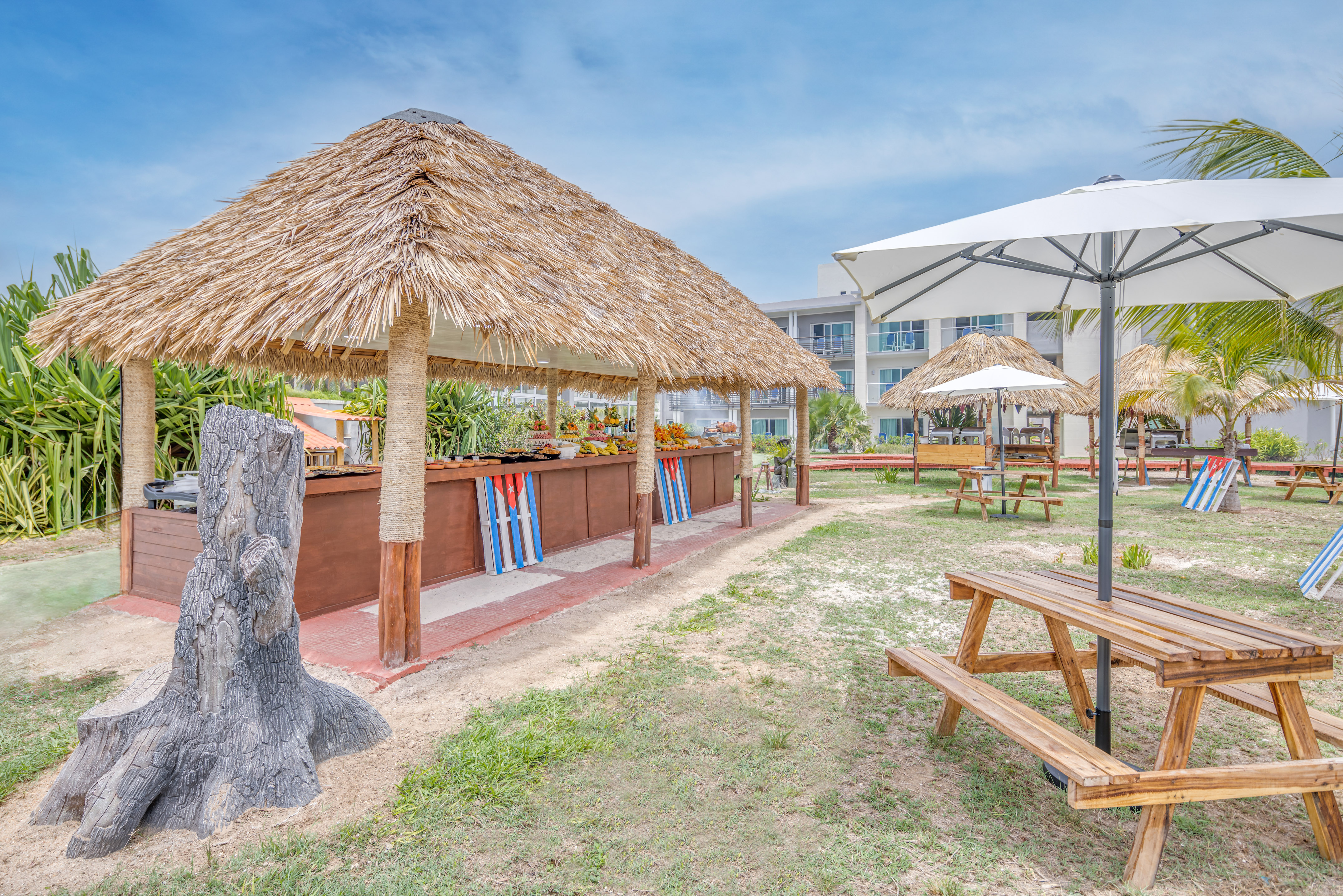 a picnic table and umbrellas in a yard