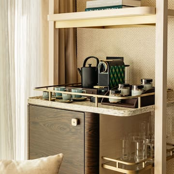 a shelf with a tea kettle and cups on it