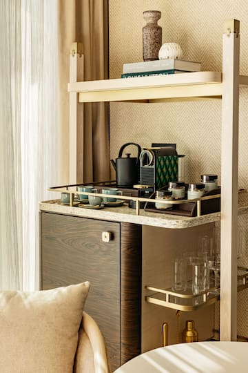 a shelf with a tea kettle and cups on it