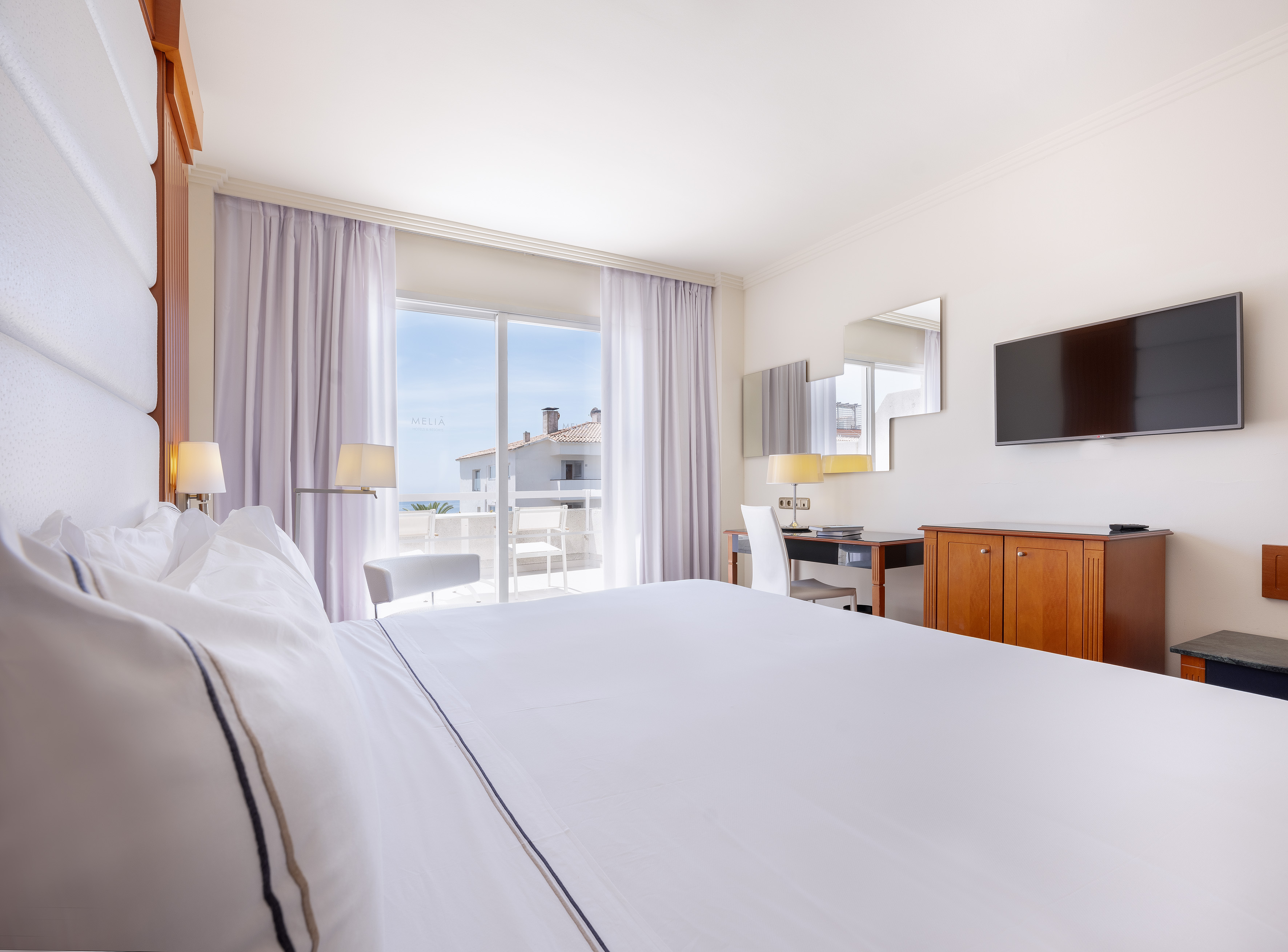 a room with a bed and a television