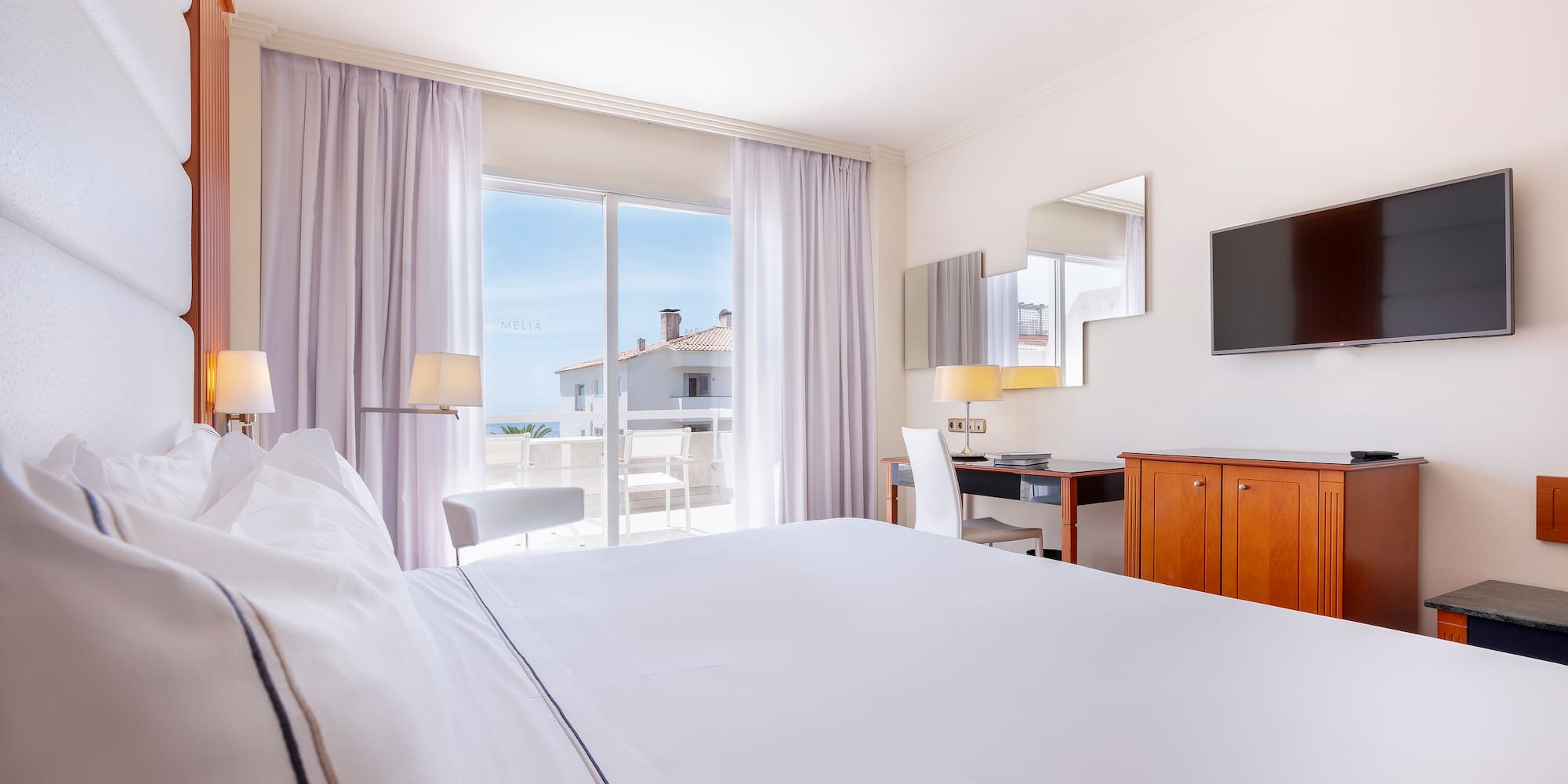 a room with a bed and a television