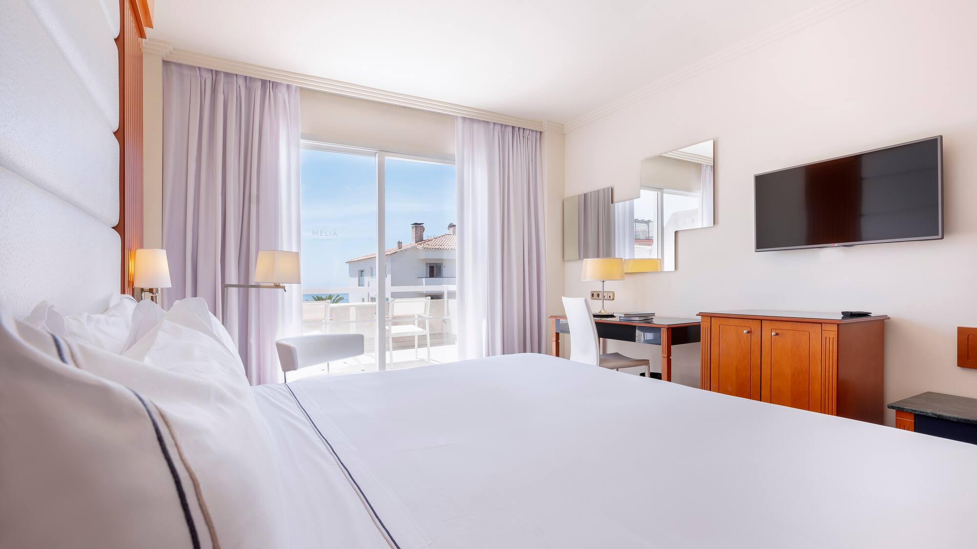 a room with a bed and a television