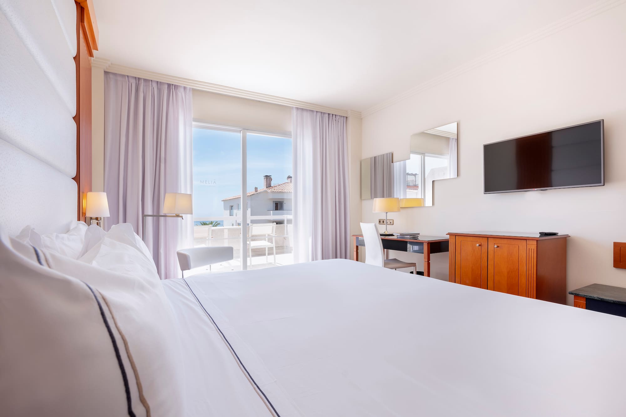 a room with a bed and a television