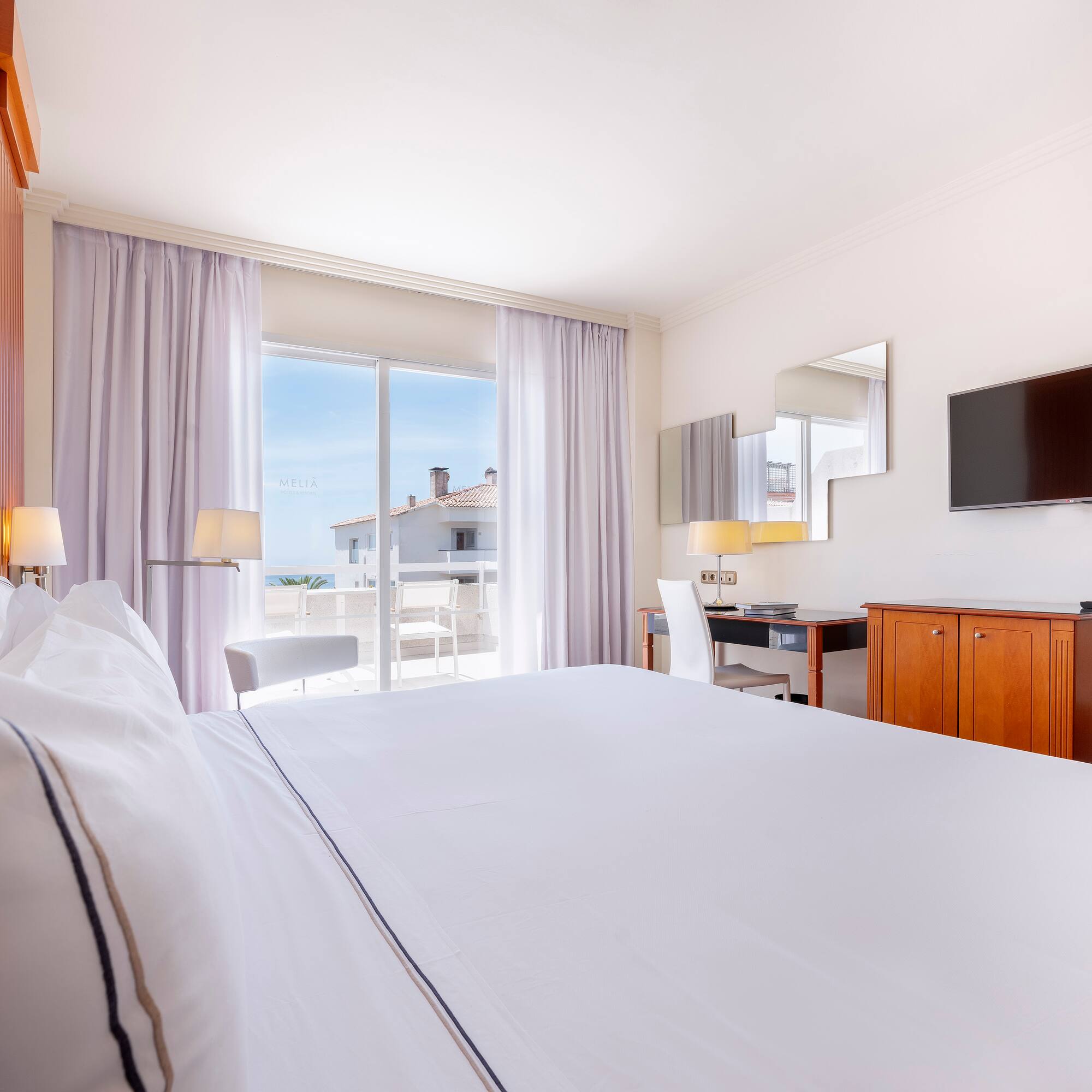 a room with a bed and a television