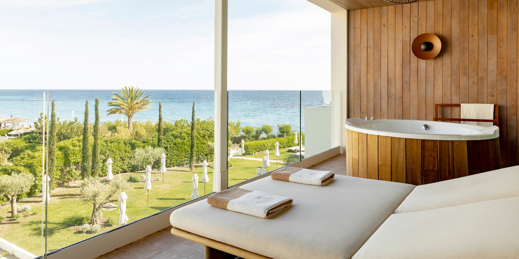 a room with a jacuzzi and a view of the ocean