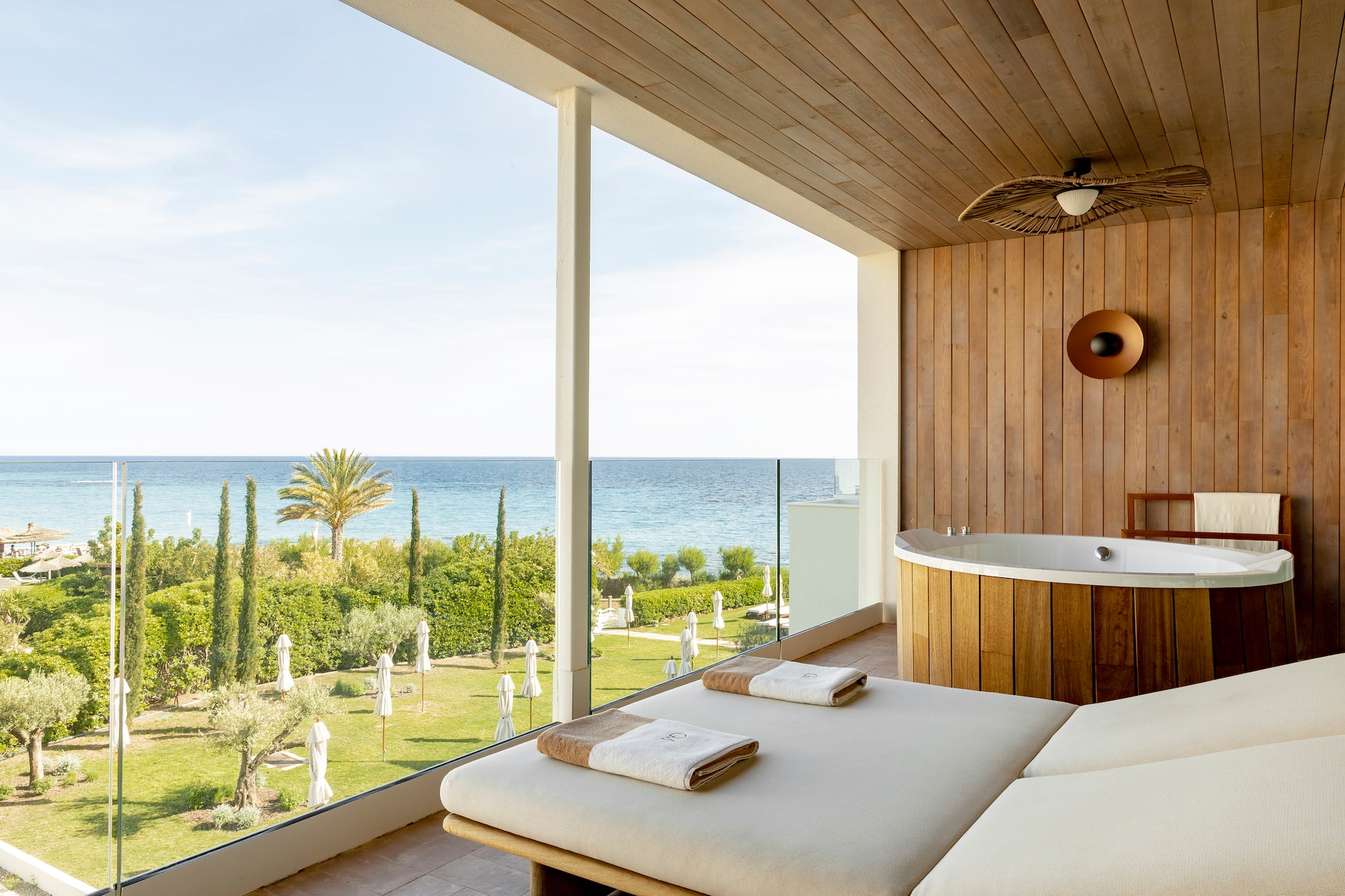a room with a jacuzzi and a view of the ocean