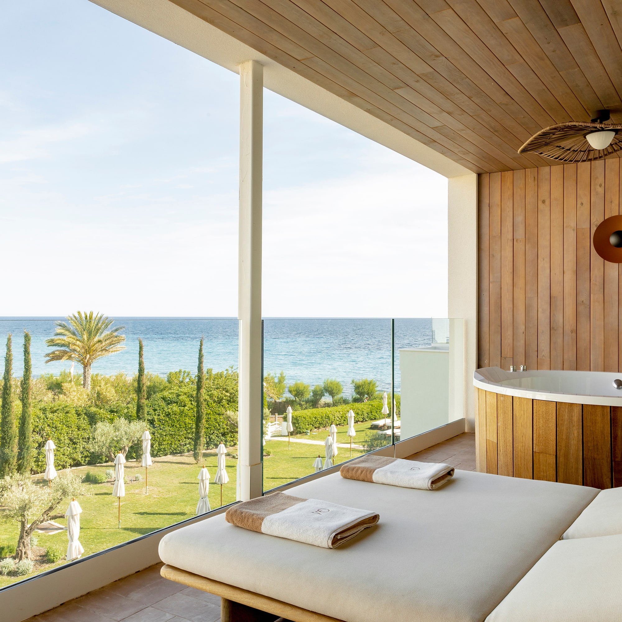 a room with a jacuzzi and a view of the ocean