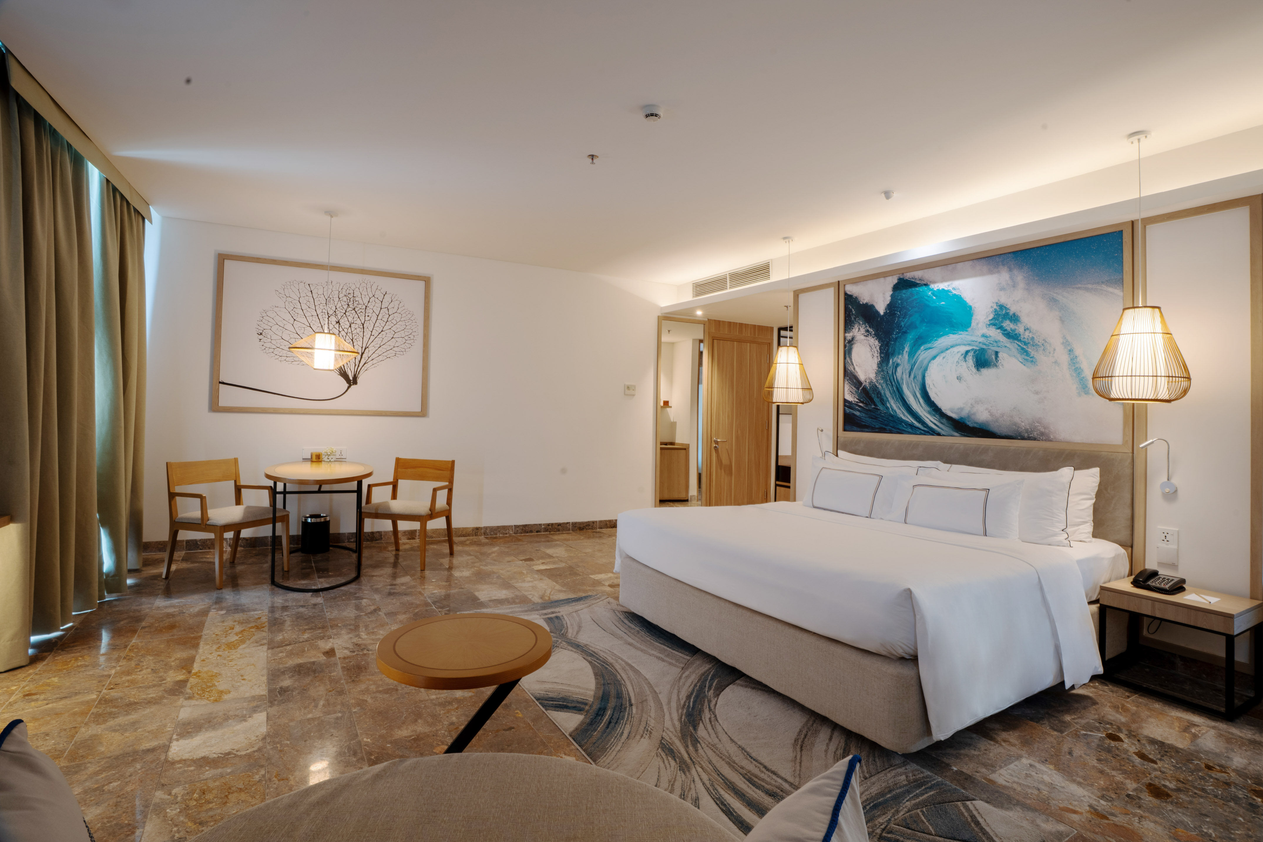 a room with a bed and chairs