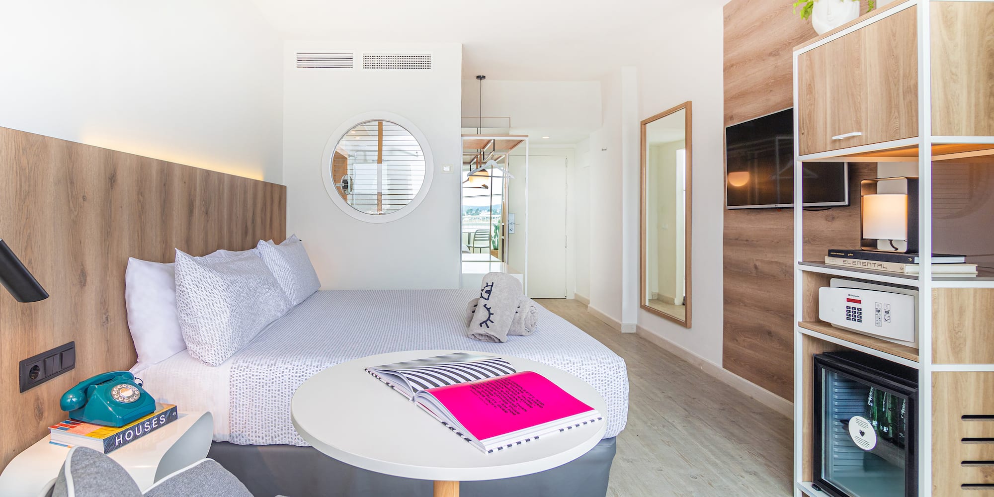 a room with a bed and a television