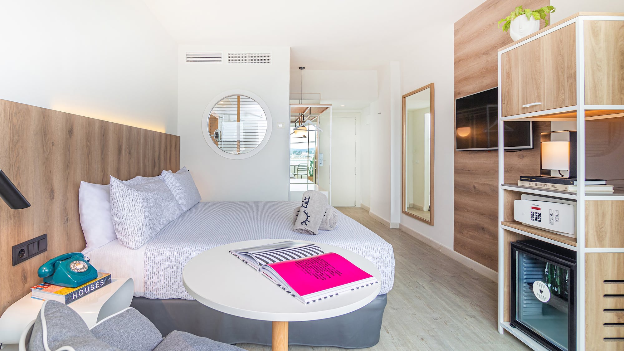 a room with a bed and a television