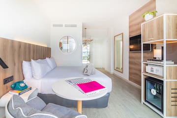 a room with a bed and a television