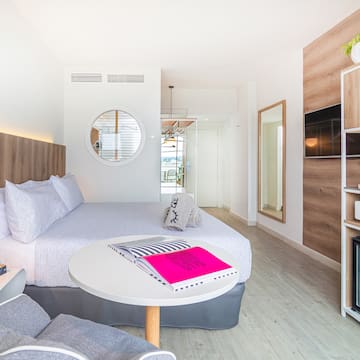 a room with a bed and a television