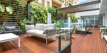 a patio with a couch and chairs