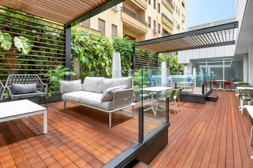 a patio with a couch and chairs