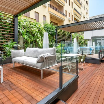 a patio with a couch and chairs