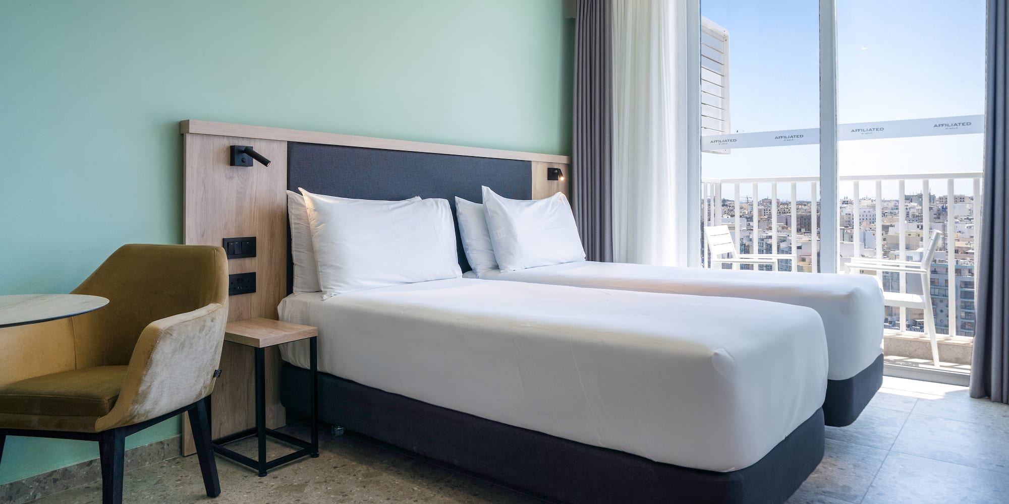 a room with two beds and a window