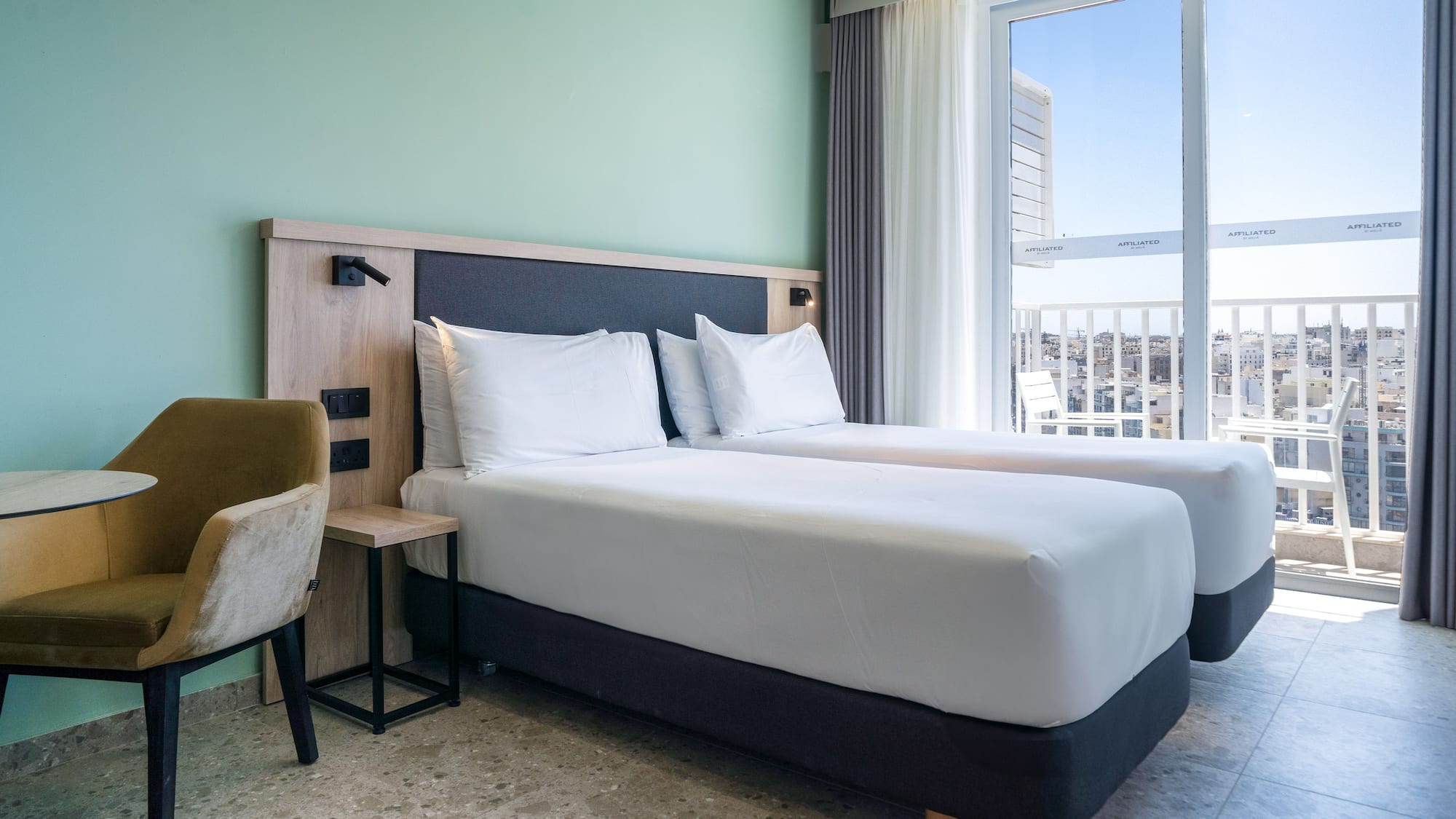 a room with two beds and a window