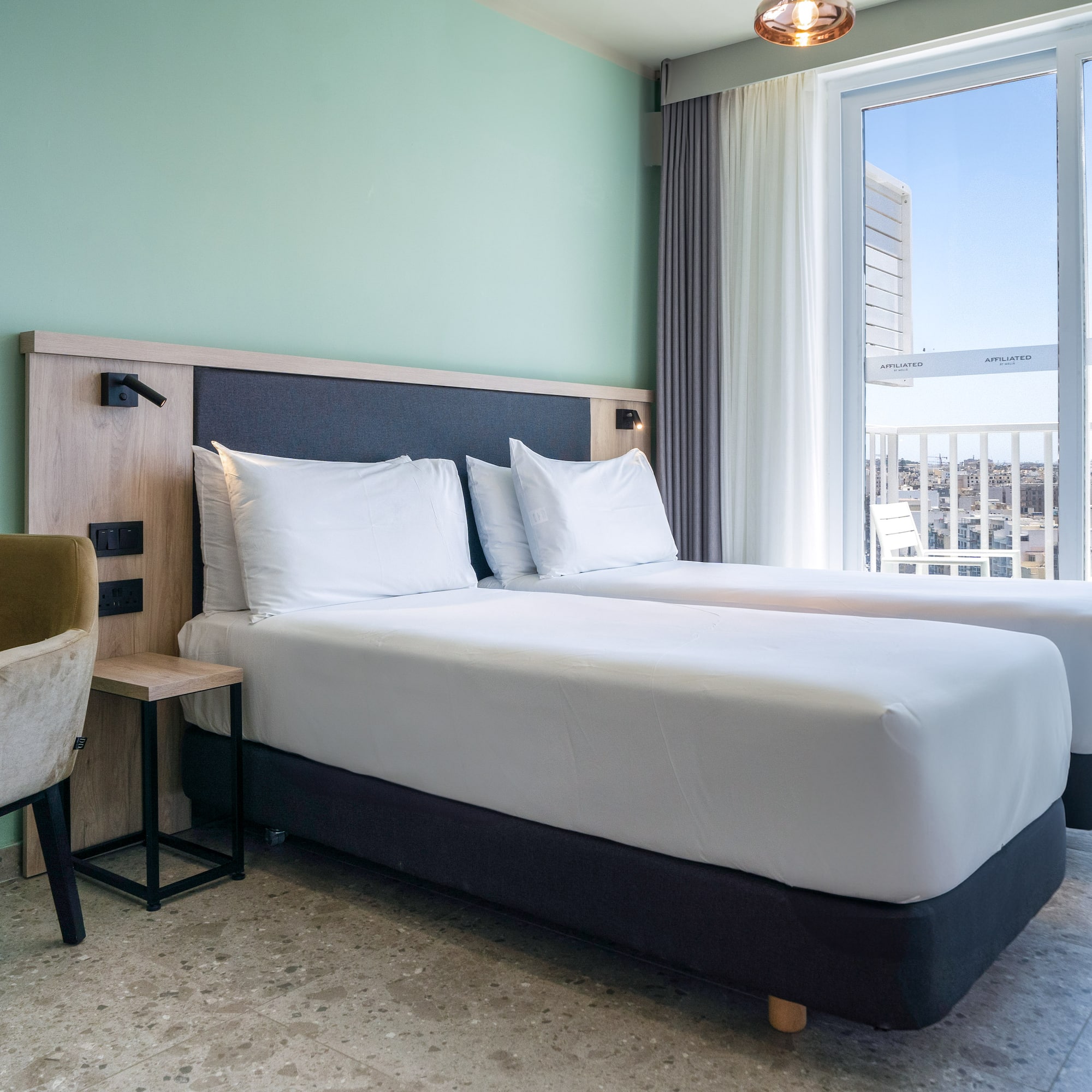 a room with two beds and a window