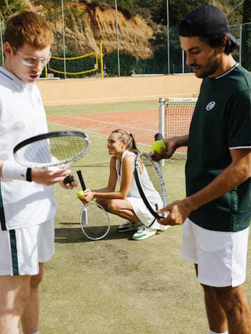 a group of people on a tennis court