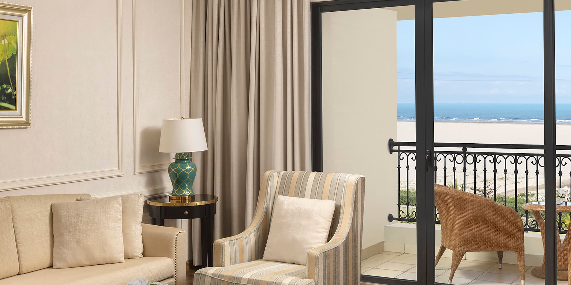 a living room with a glass door and a balcony