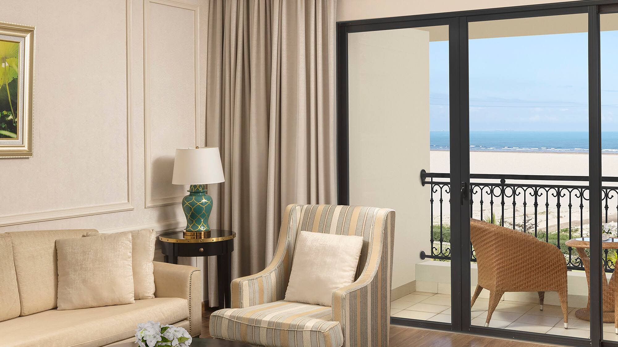 a living room with a glass door and a balcony