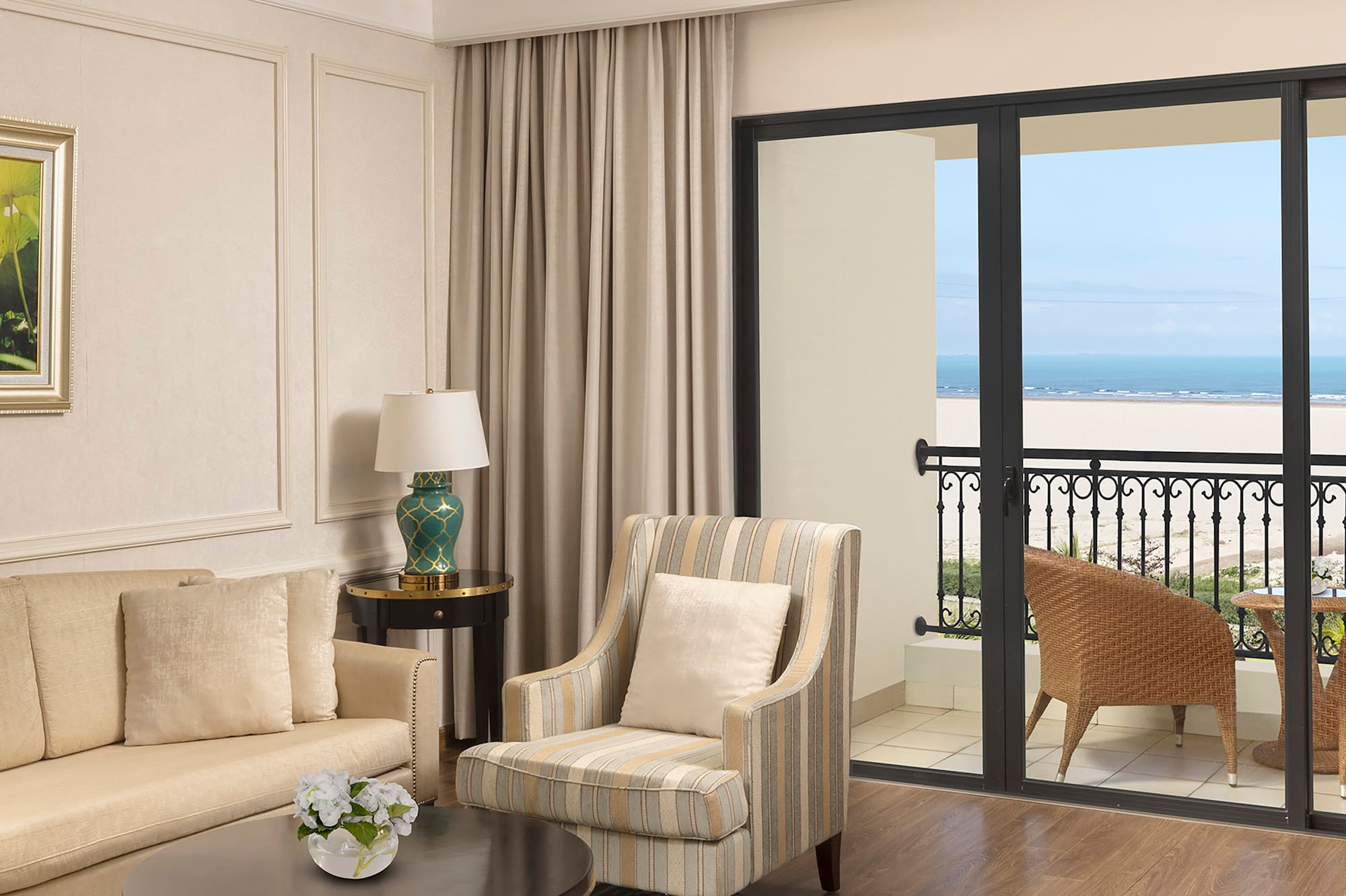 a living room with a glass door and a balcony