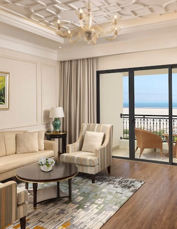 a living room with a glass door and a balcony