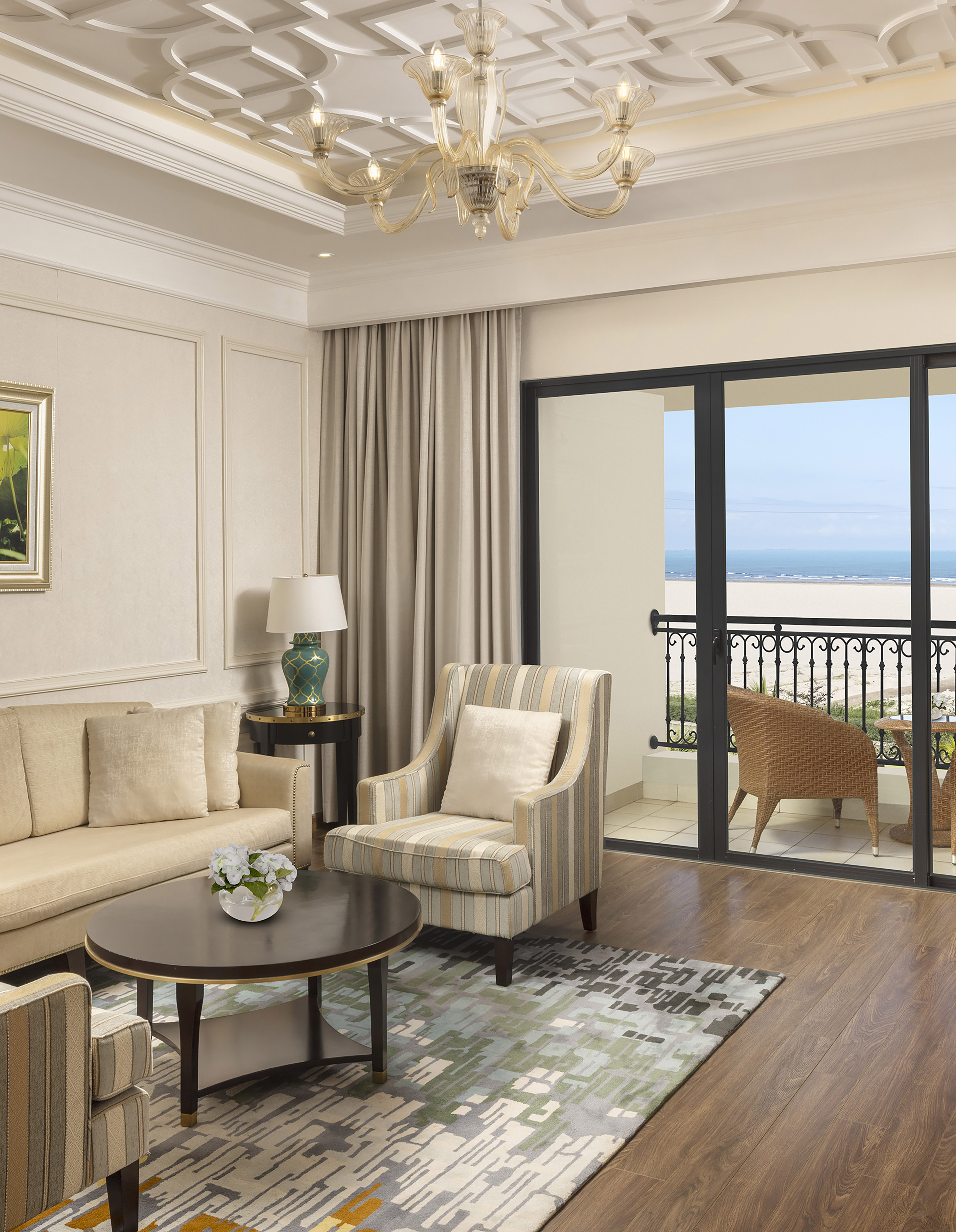 a living room with a glass door and a balcony