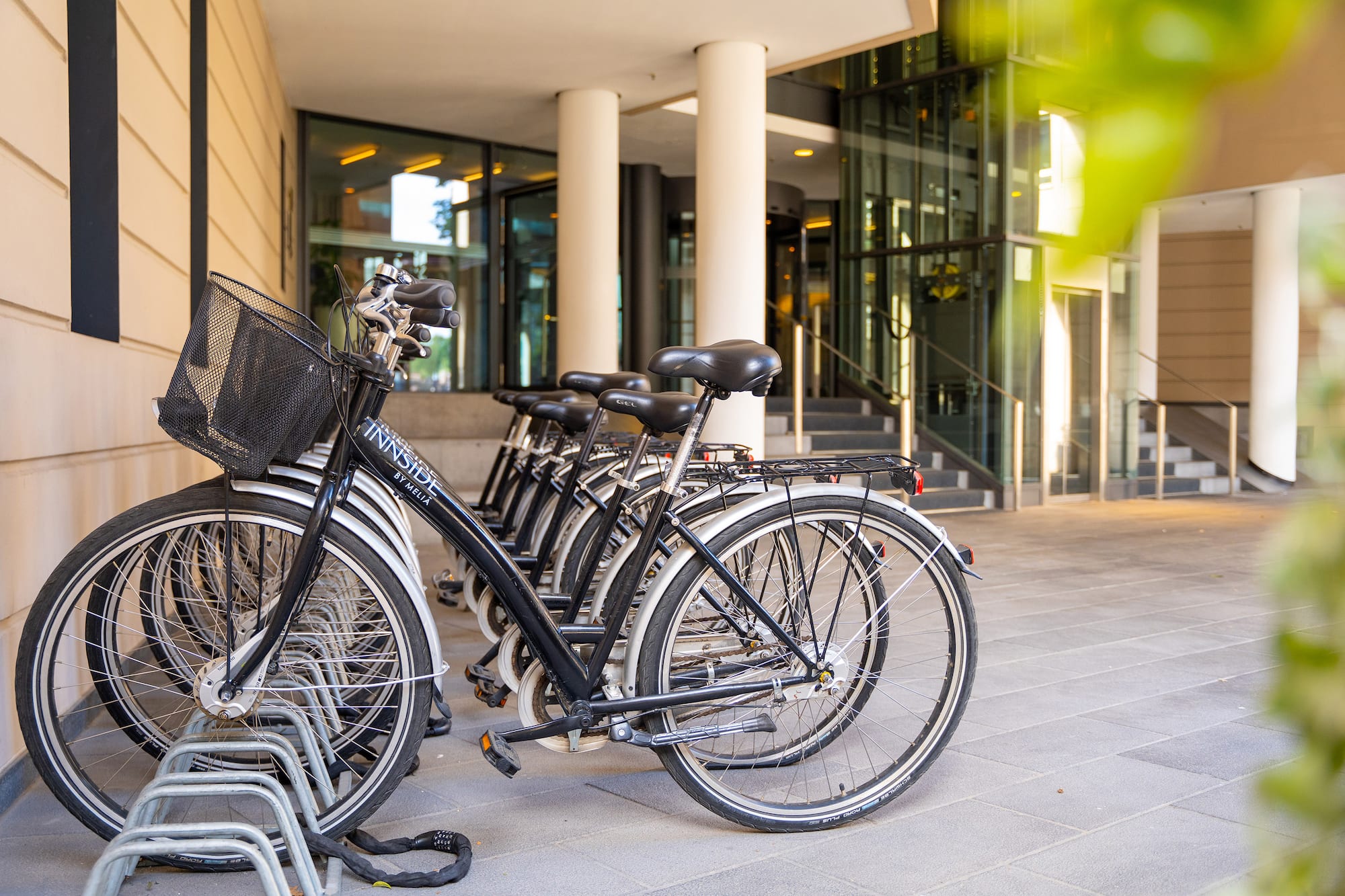 Innside by Meliá hotel bikes parked on a rack outside a modern building.