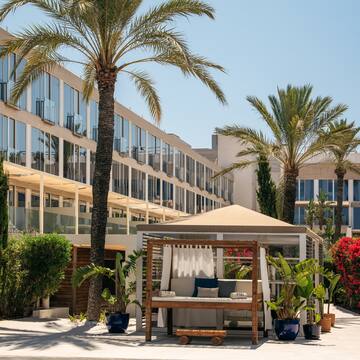 a building with palm trees and a gazebo