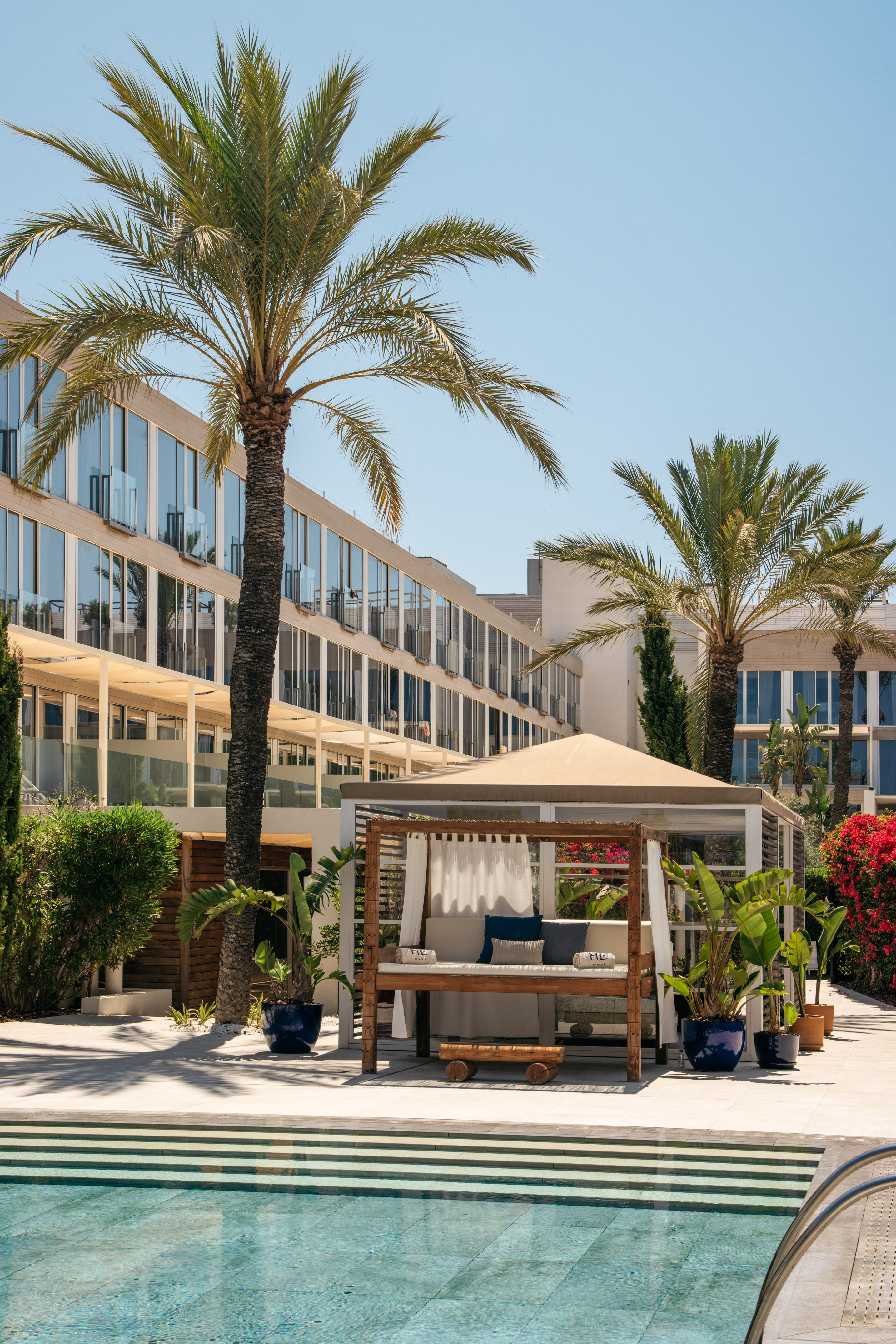 a building with palm trees and a gazebo
