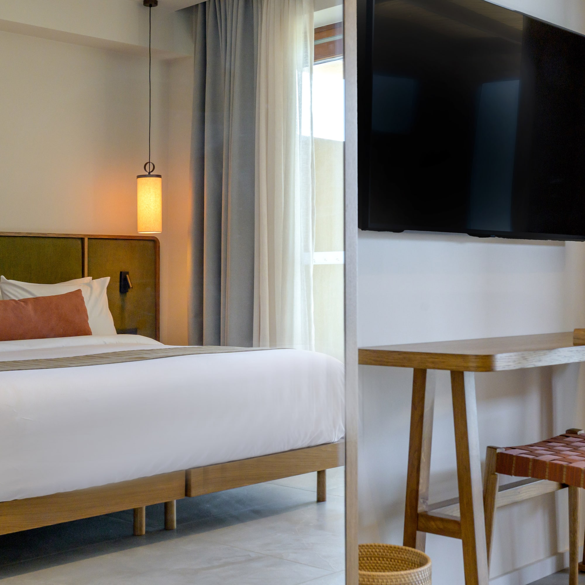 a room with a bed and a television on the wall.