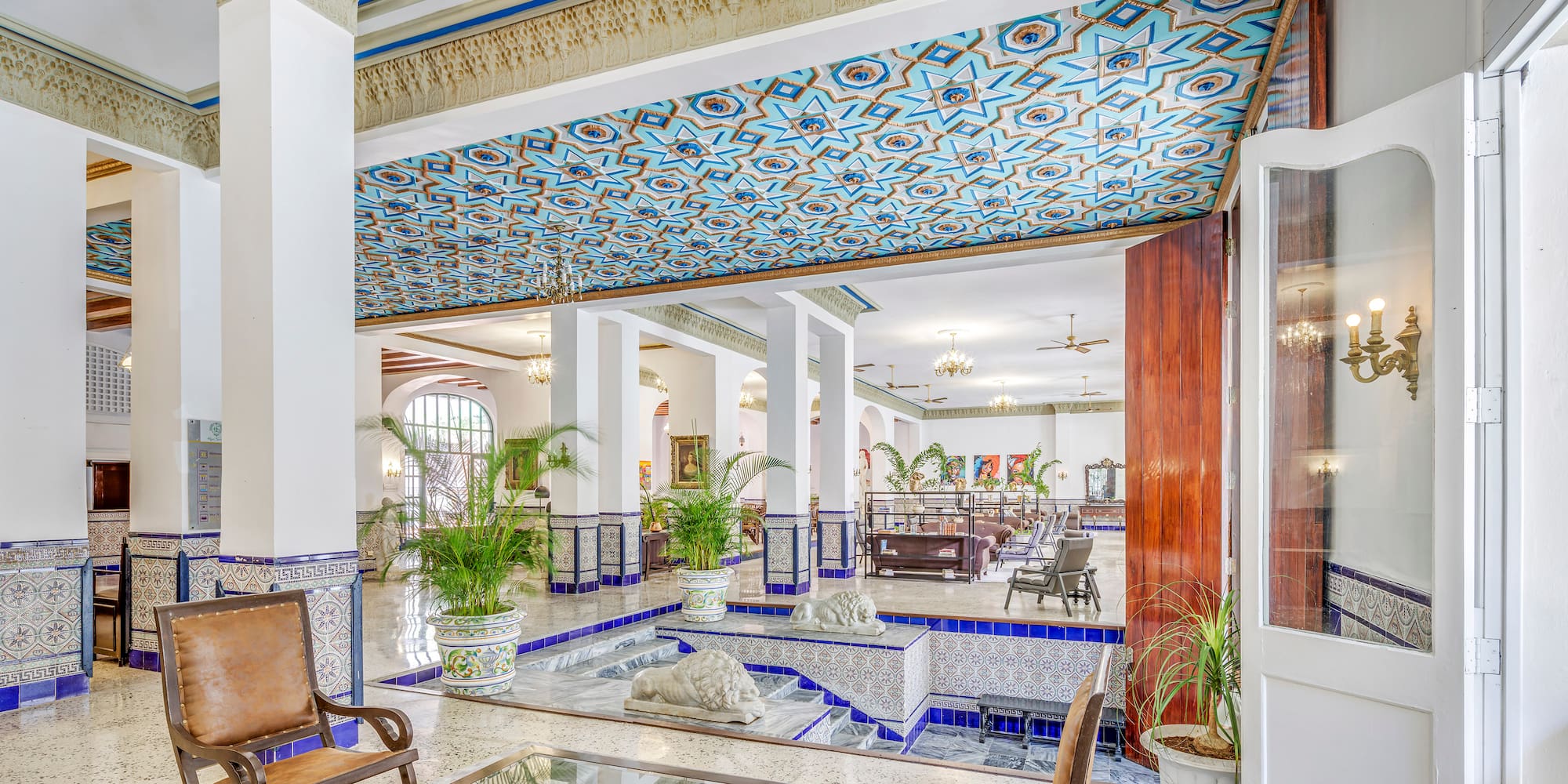 a room with a glass table and chairs