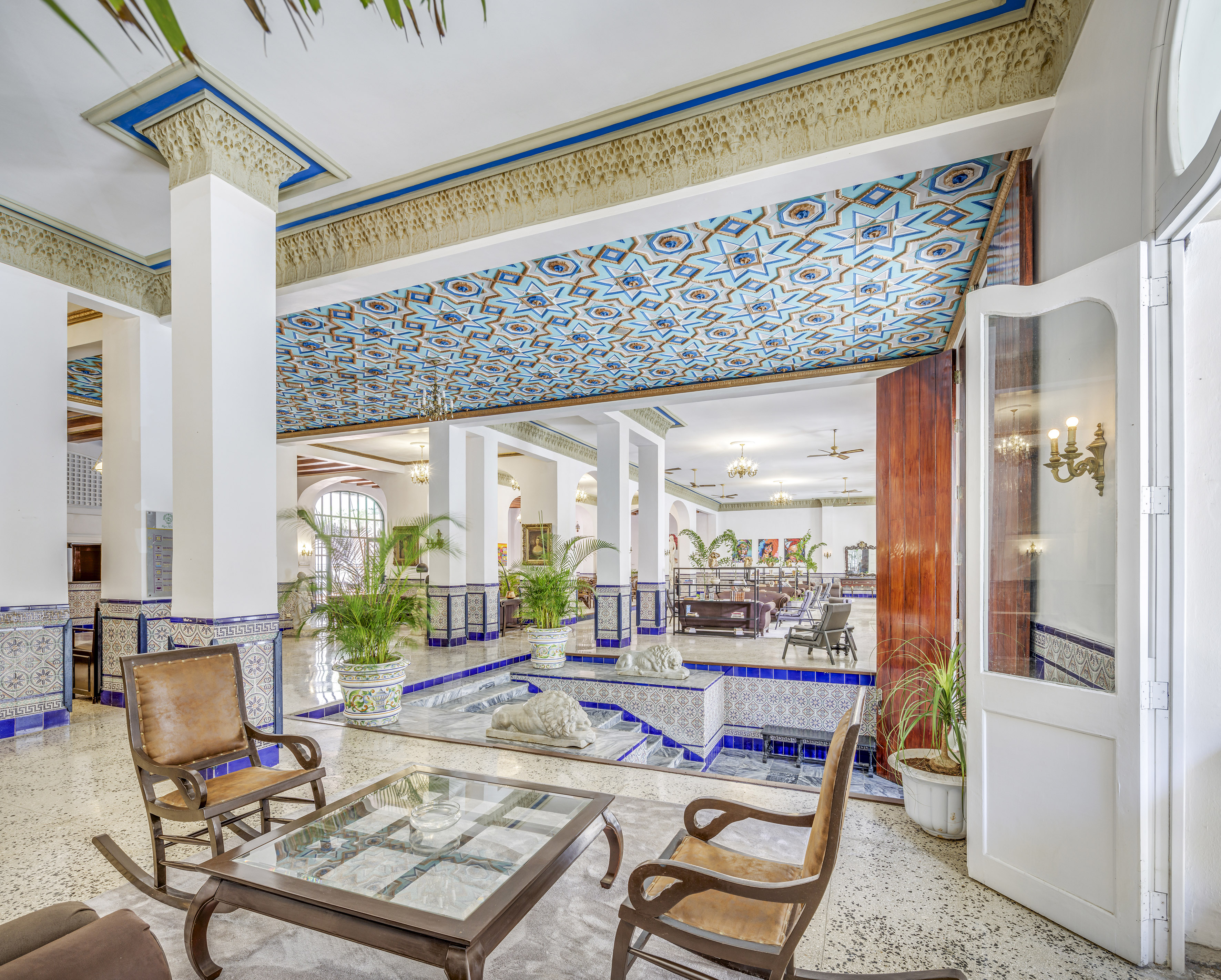 a room with a glass table and chairs