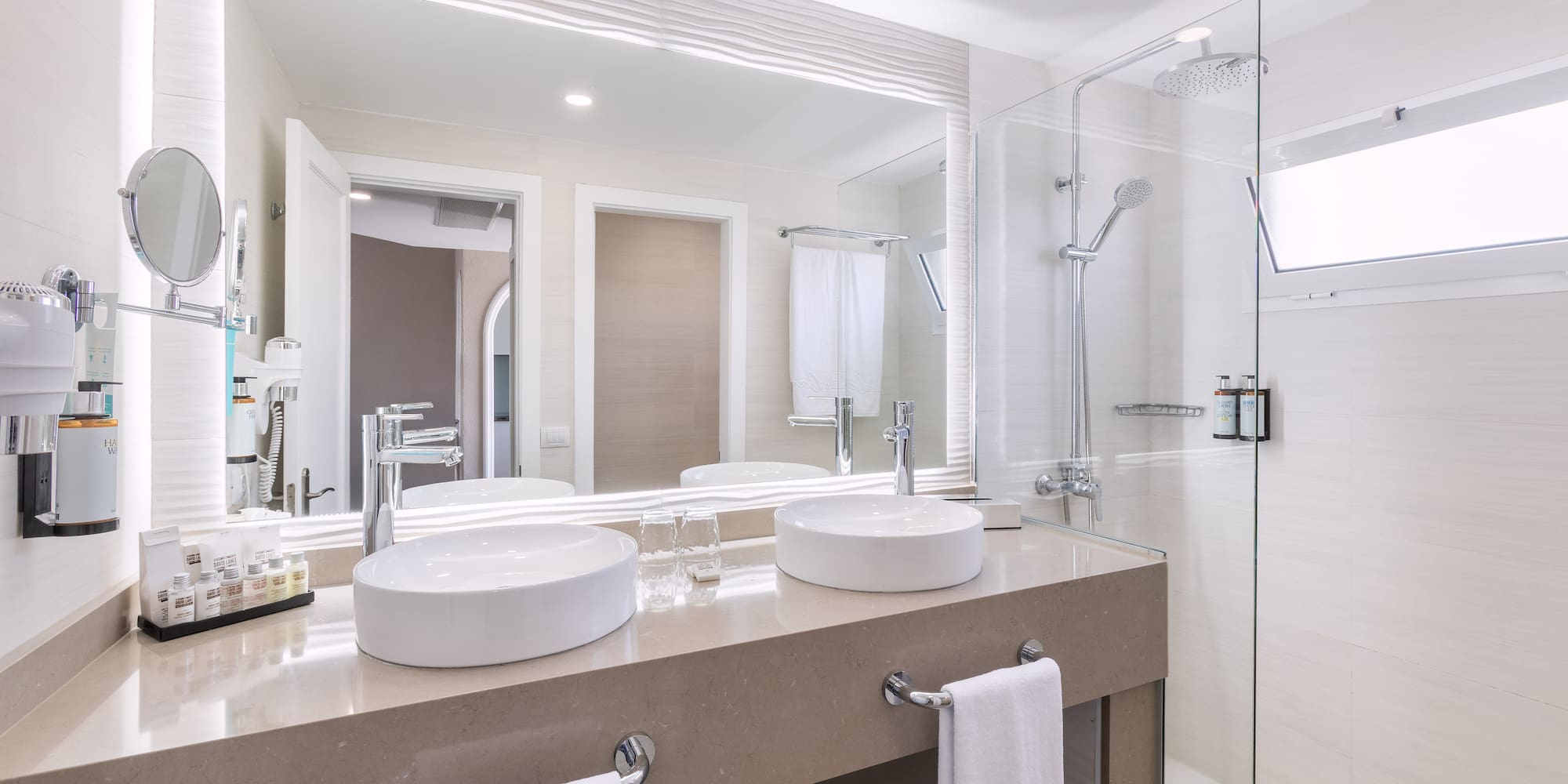 a bathroom with a shower and two sinks