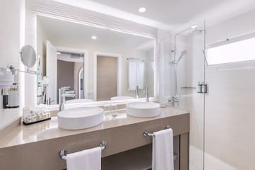 a bathroom with a shower and two sinks
