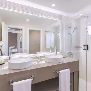 a bathroom with a shower and two sinks