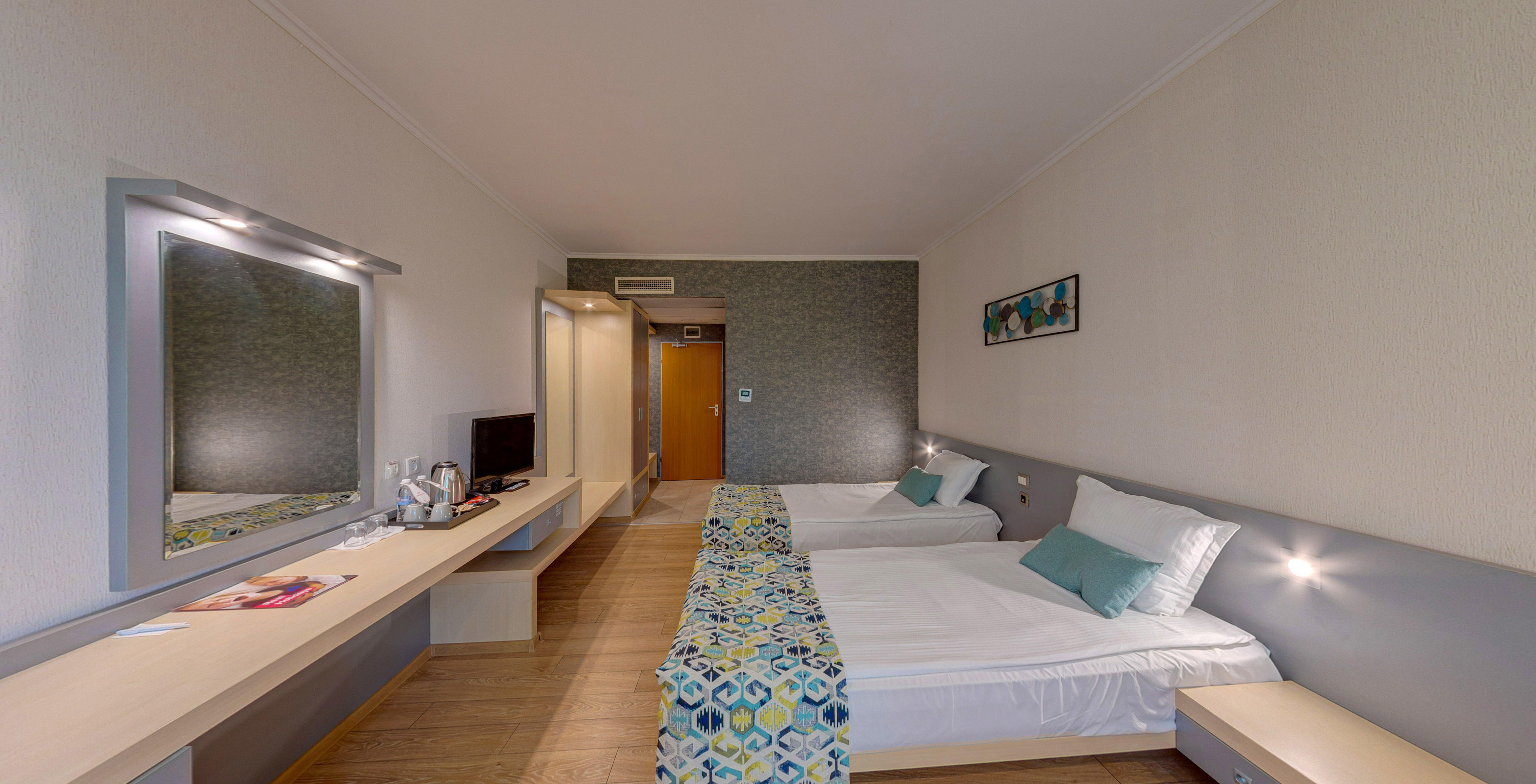 a room with two beds and a desk