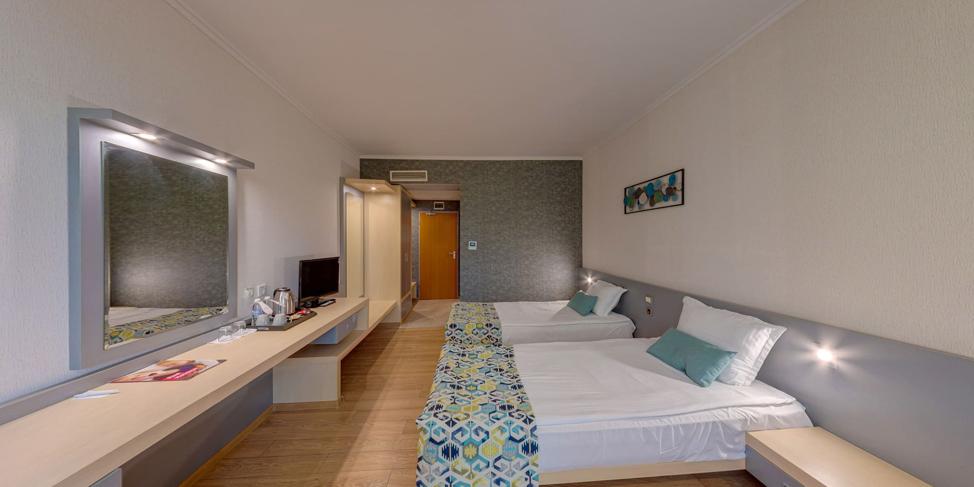 a room with two beds and a desk