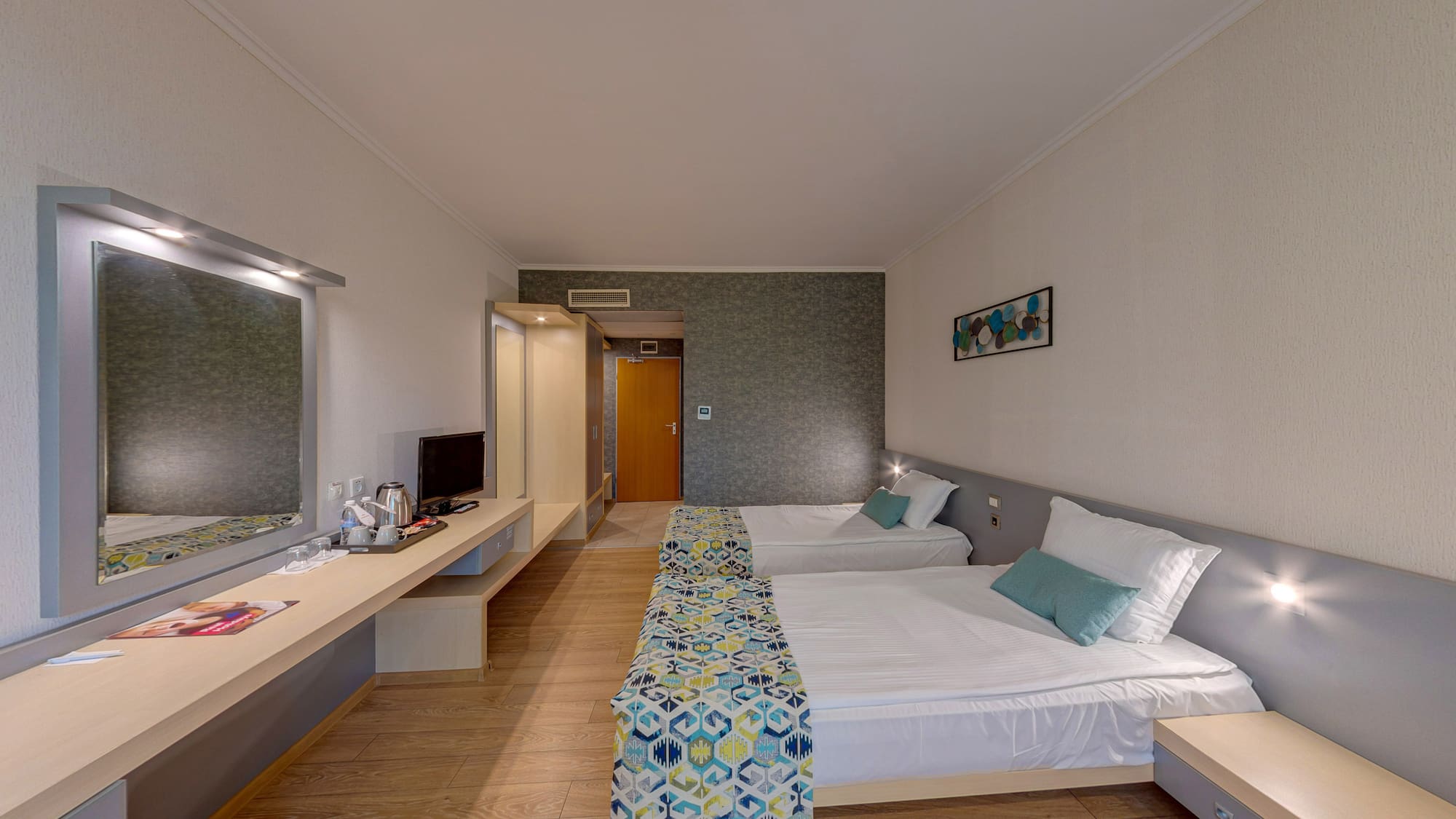 a room with two beds and a desk