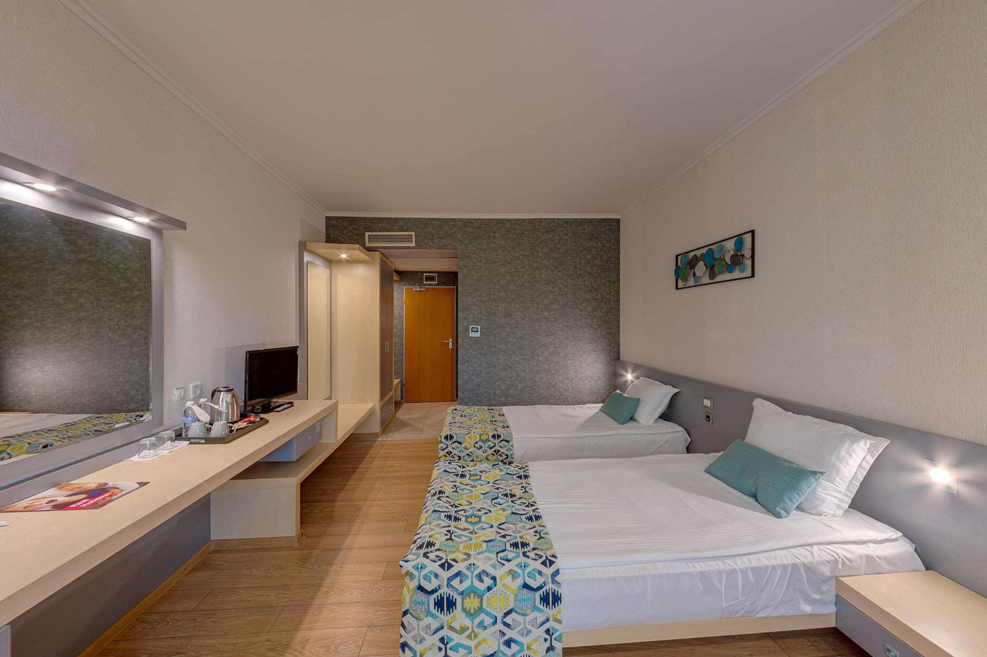 a room with two beds and a desk