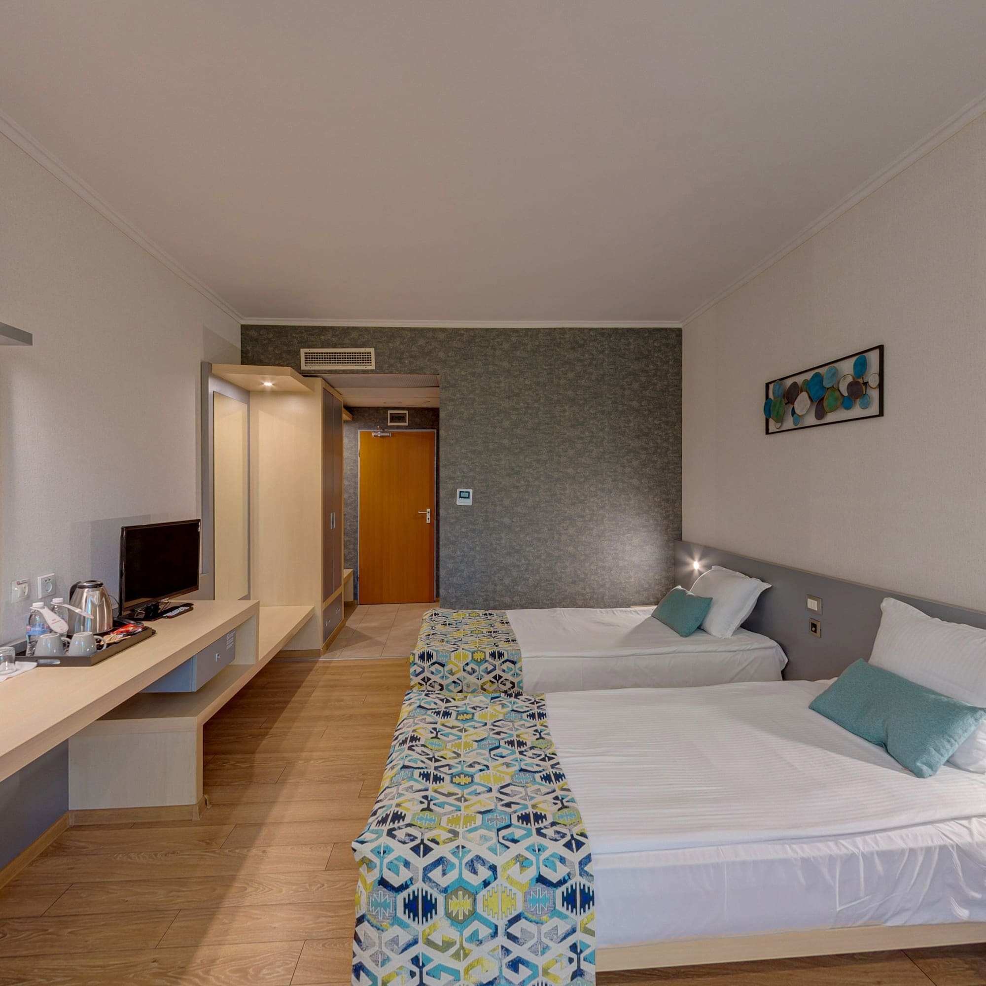 a room with two beds and a desk