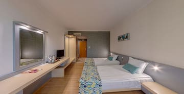 a room with two beds and a desk