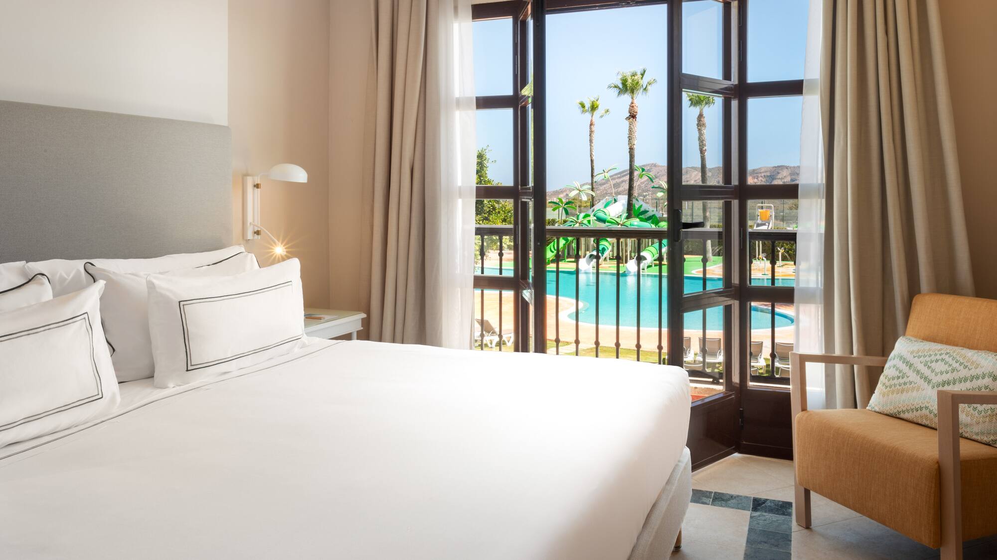 a room with a bed and a pool outside