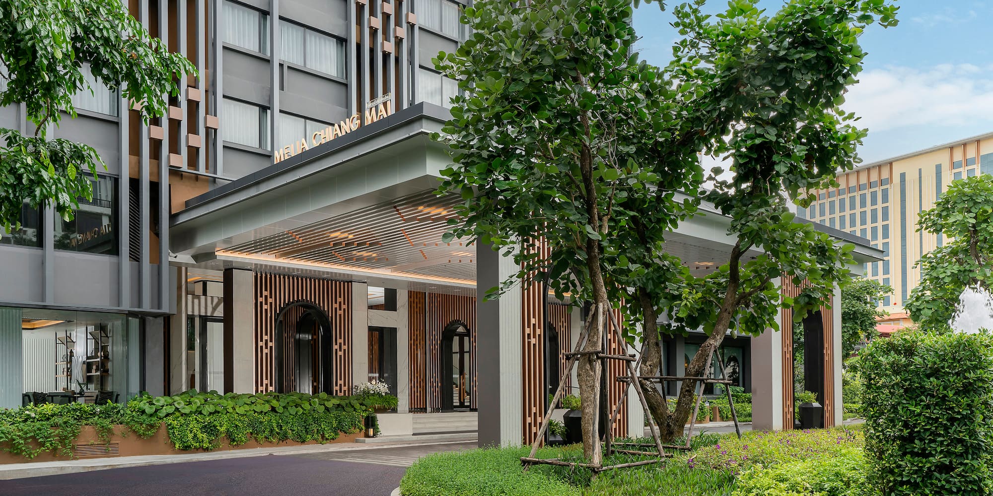 a building with trees and a walkway