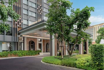 a building with trees and a walkway