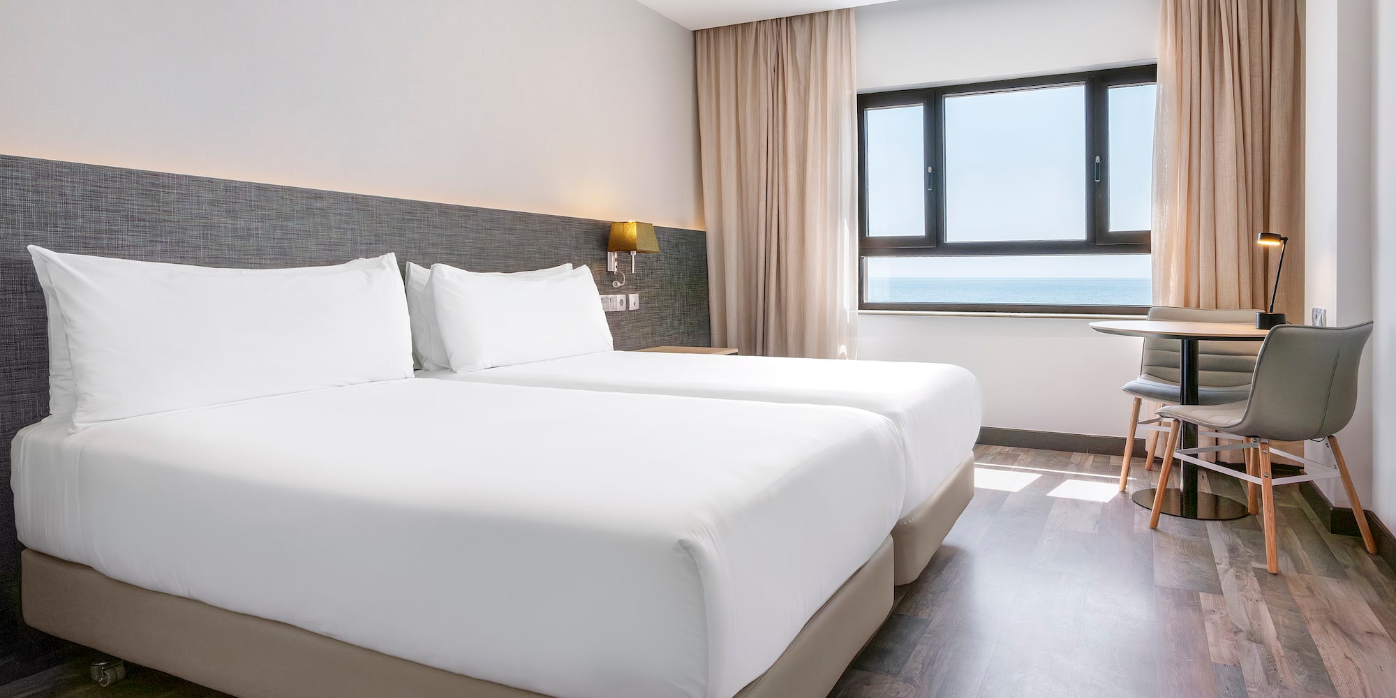 a room with two beds and a table