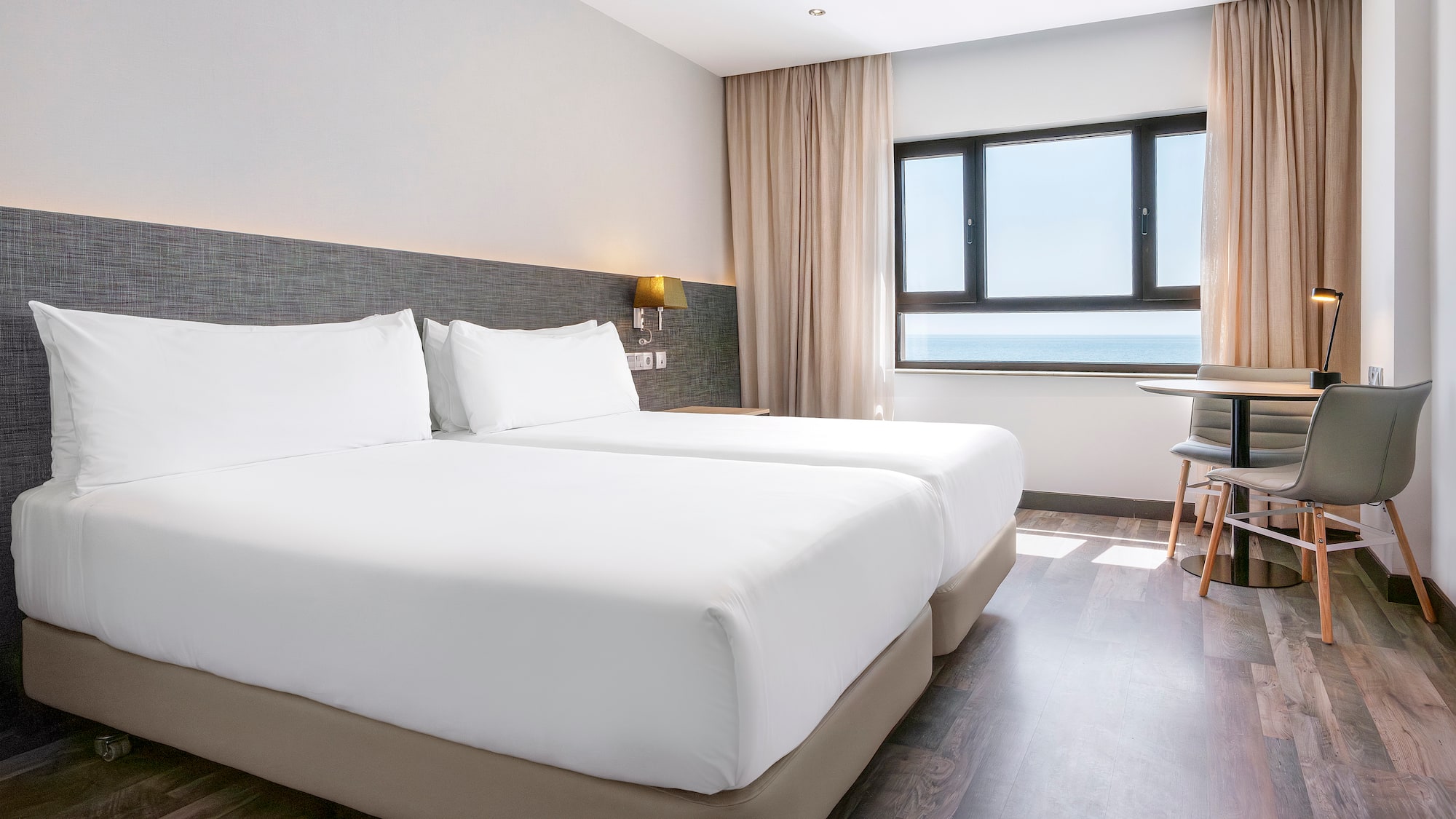 a room with two beds and a table