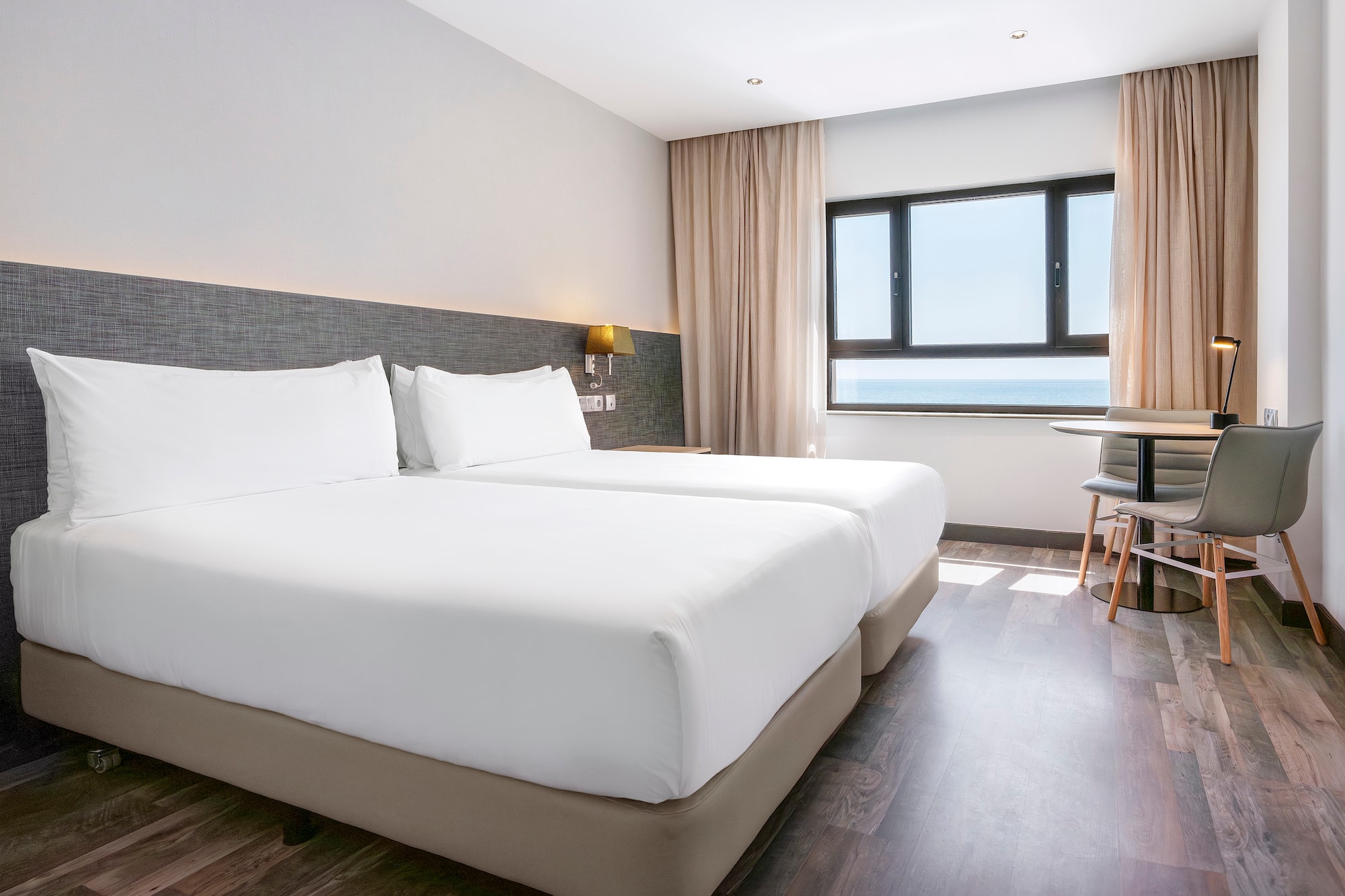 a room with two beds and a table