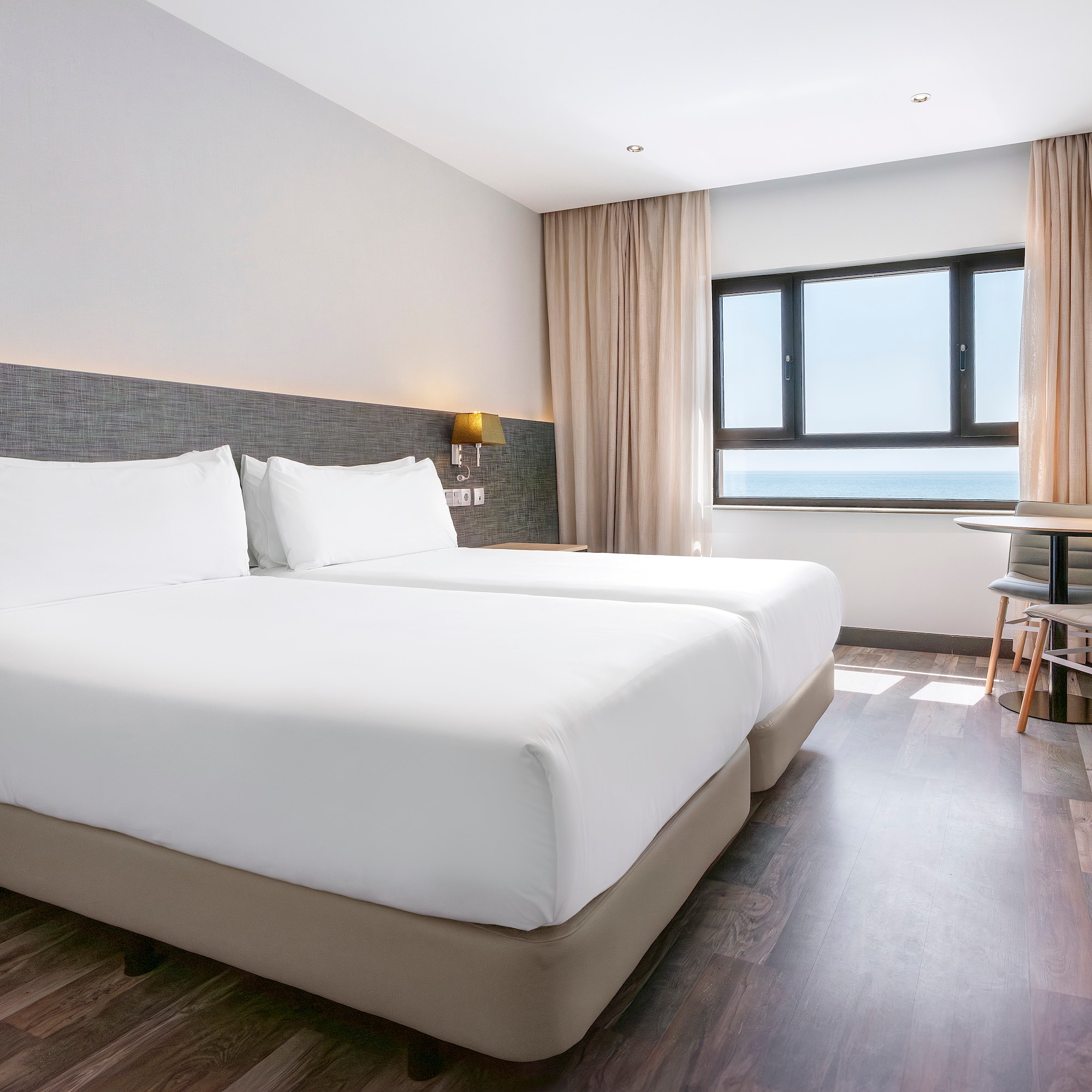 a room with two beds and a table